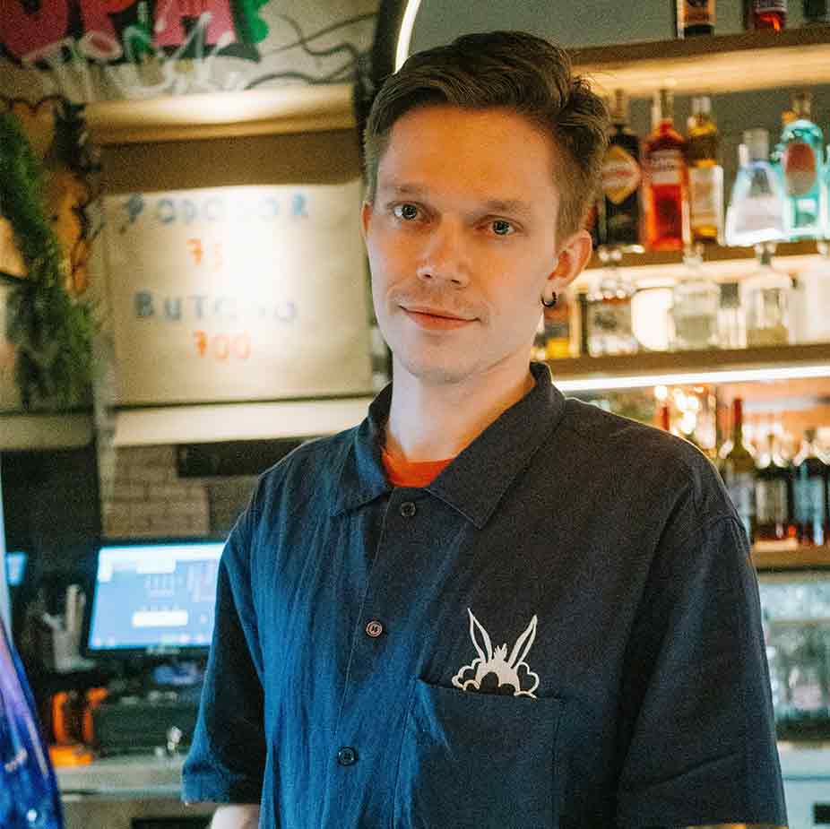 Portrait of Gerrard wearing a black chef outfit looking at the camera